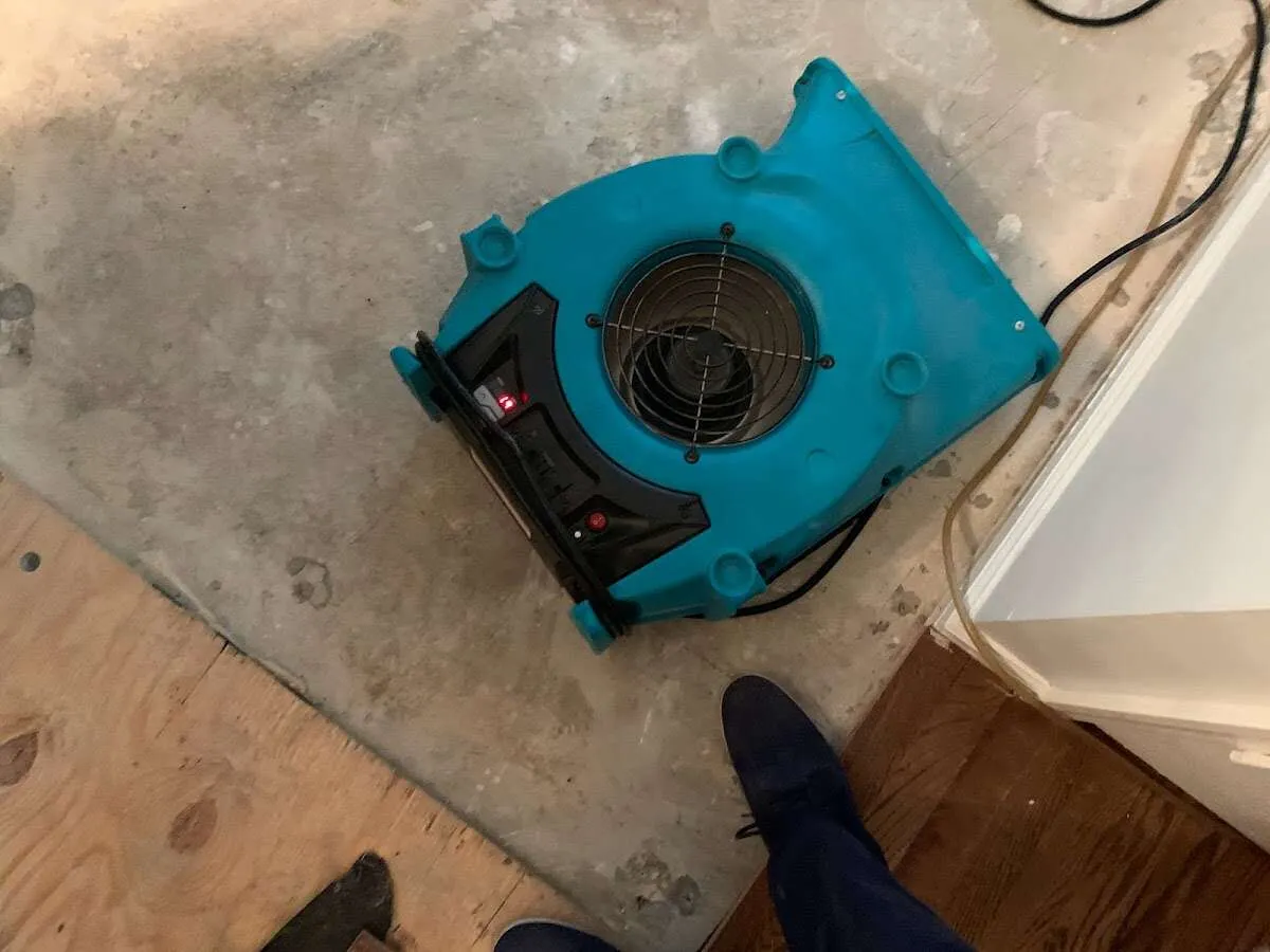 Air mover drying subfloor during Leak Detection & Repair in Maine
